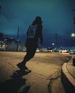 Shadow of man on city street at night