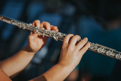 Close-up of hands playing the flute