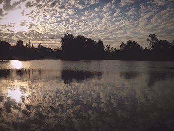 Scenic view of lake against sky at sunset