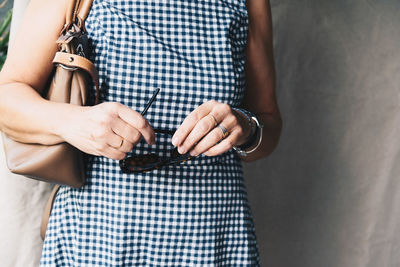 Midsection of woman with purse