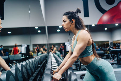 Young woman exercising in gym