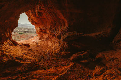 Large orange cave with small dog outside of st. george utah