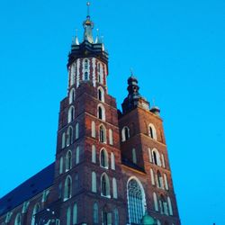 Low angle view of bell tower against blue sky