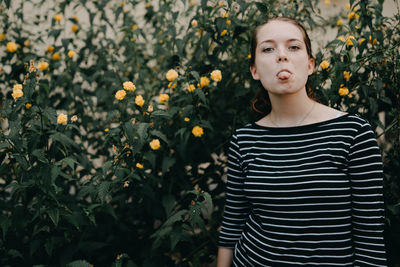 Portrait of cute girl standing by plants