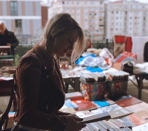 Side view of young woman looking at library