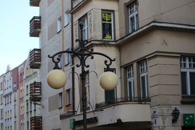 Low angle view of street light against building