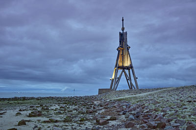 Tower on field against sky