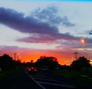 Road against cloudy sky at sunset