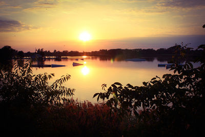 Scenic view of lake against romantic sky at sunset