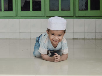 Portrait of boy sitting on table