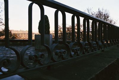 Close-up of metallic structure against sky