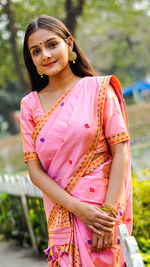 Portrait of beautiful young woman standing outdoors