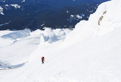 A man climbs down from the summit of mt. hood in oregon.