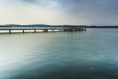 Pier over sea against sky