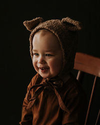 Toddler baby boy in funny costume with ears sitting and laughing