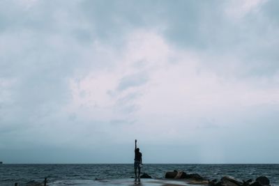 Scenic view of sea against cloudy sky