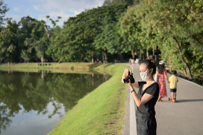 Series photo of young women with camera in public park outdoor on sunny day