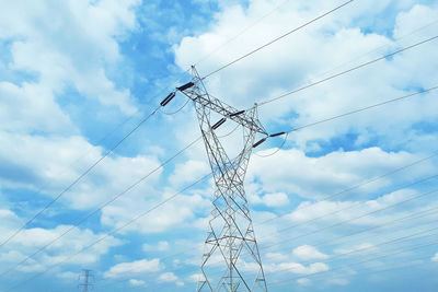 Low angle view of power lines against sky