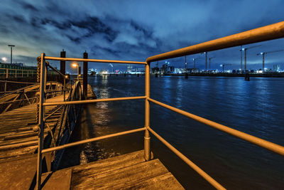 Bridge over river against sky at dusk