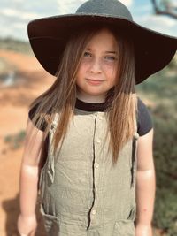 Portrait of a smiling young woman wearing hat