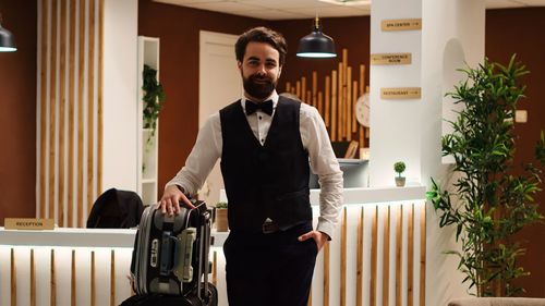 Portrait of young man using mobile phone in office