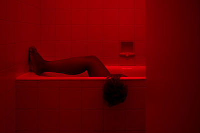 Low section of woman in bathtub