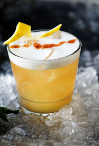 Close-up of lemonade in glass on crushed ice