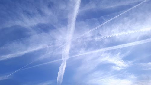 Low angle view of vapor trail in blue sky