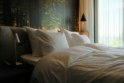 Bedroom in cozy modern interior design home or hotel. soft pillows and blanket. dark wall and room.