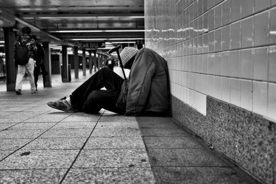 Rear view of a young man sitting on bench