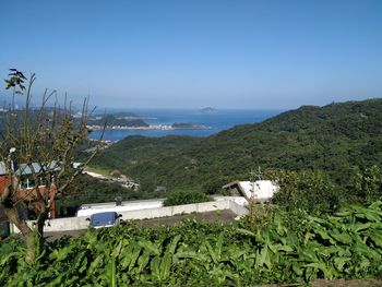 Scenic view of sea and mountains against sky