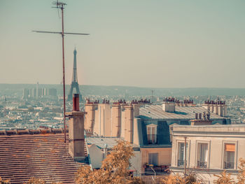 Buildings in city against clear sky