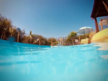 View of swimming pool against blue sky