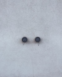 Concrete wall texture with two hydrant valves.