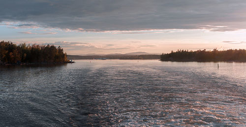 Scenic view of lake against sky at sunset