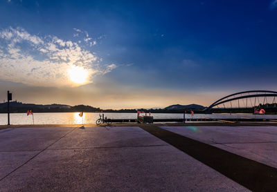 Bridge over river against sky during sunset