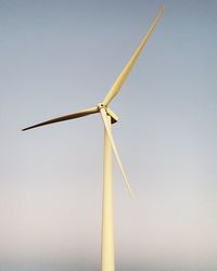 Low angle view of wind turbine against sky