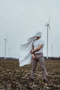 Man covered face wind turbines