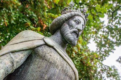 Low angle view of statue against trees