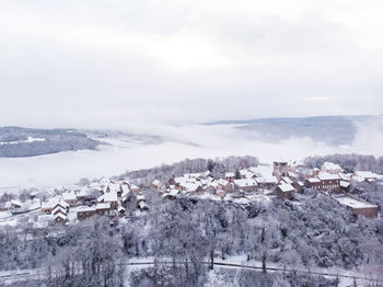 Scenic view of townscape against sky during winter