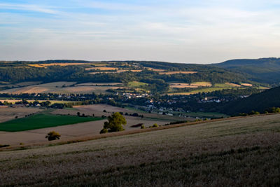 Scenic view of agricultural field against sky