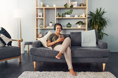 Woman sitting on sofa at home