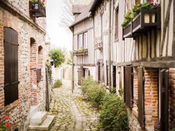 View of alley amidst buildings in town