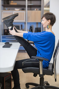 Side view of woman using mobile phone at airport