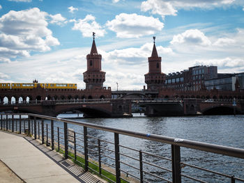 Oberbaum bridge over spree river against sky in city