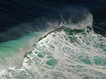 Close up of wave splashing and curling in sea
