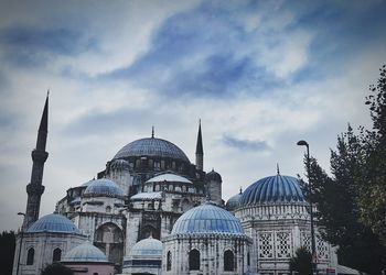 Low angle view of mosque in city against sky