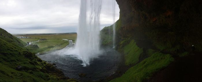 Scenic view of waterfall against sky