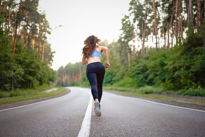 Full length of woman running on road