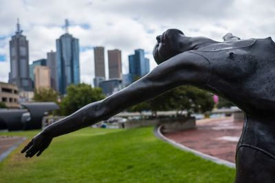 Statue of woman with building in background